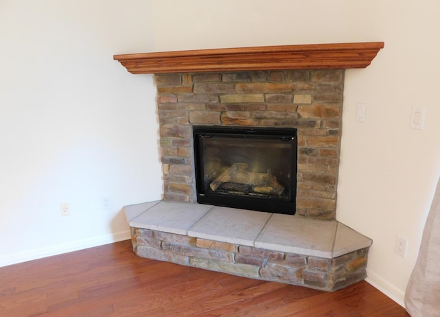 2535 Holiday House Rd Unit 24, Saint Joseph, MI 49085 - detailed view of wood finished floors, baseboards, and a glass covered fireplace
