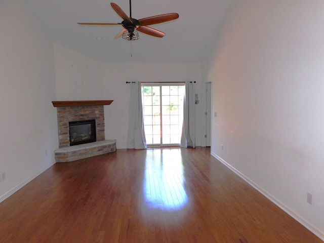 2535 Holiday House Rd Unit 24, Saint Joseph, MI 49085 - unfurnished living room with ceiling fan, wood finished floors, a stone fireplace, baseboards, and high vaulted ceiling