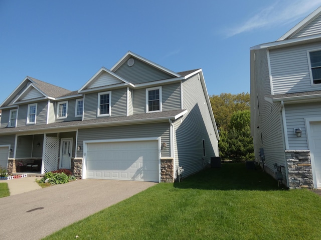 2535 Holiday House Rd Unit 24, Saint Joseph, MI 49085 - view of front facade with an attached garage, a front lawn, driveway, central AC unit, and stone siding