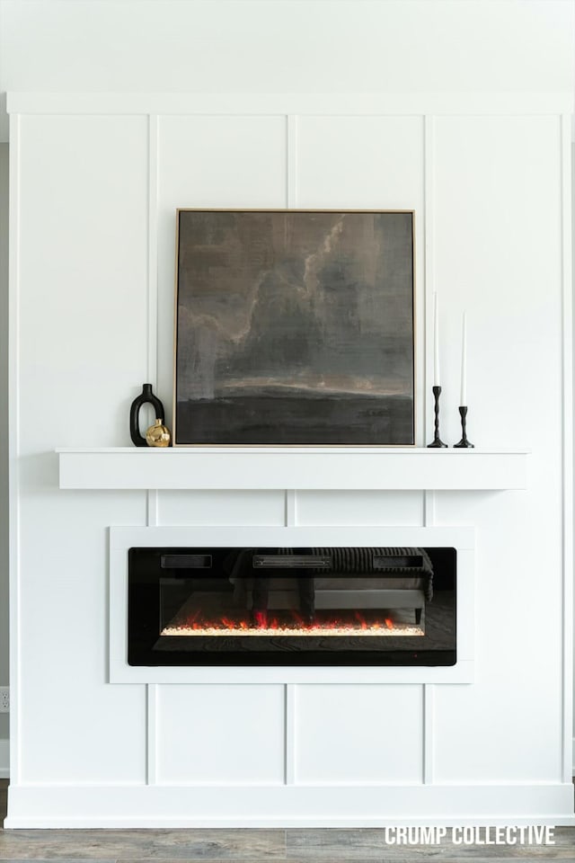 room details featuring a fireplace and wood finished floors