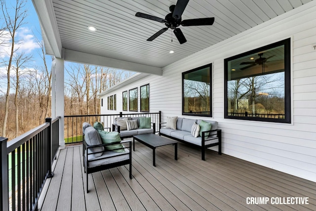 wooden deck with an outdoor hangout area and ceiling fan