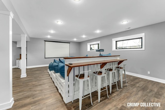 cinema room with dark wood finished floors, baseboards, and recessed lighting