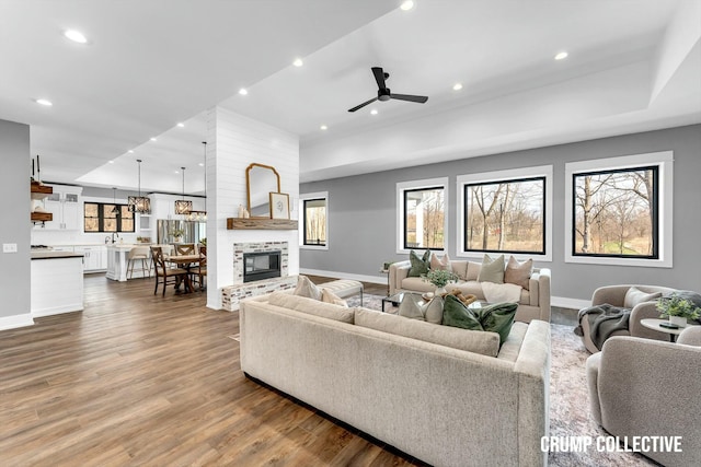 living area featuring baseboards, recessed lighting, and dark wood finished floors