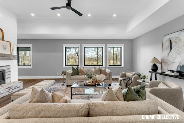 living area featuring baseboards, wood finished floors, recessed lighting, and a ceiling fan