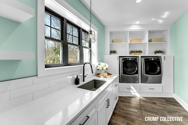 laundry area featuring recessed lighting, dark wood-style flooring, a sink, washer and dryer, and laundry area