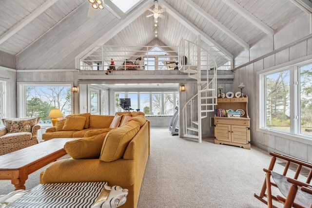 4117 Lake Shore Dr, New Buffalo, MI 49117 - carpeted living room with beamed ceiling, a ceiling fan, high vaulted ceiling, and wood walls