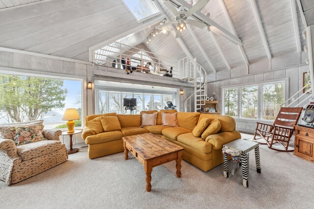 4117 Lake Shore Dr, New Buffalo, MI 49117 - living area with high vaulted ceiling, beamed ceiling, a ceiling fan, stairway, and carpet floors