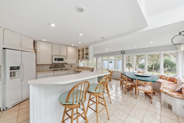 4117 Lake Shore Dr, New Buffalo, MI 49117 - kitchen with light countertops, plenty of natural light, light tile patterned floors, and white appliances