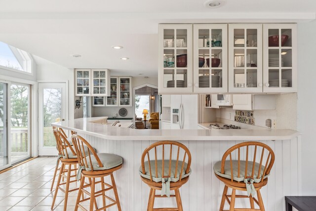 4117 Lake Shore Dr, New Buffalo, MI 49117 - kitchen featuring glass insert cabinets, light countertops, white appliances, and a wealth of natural light