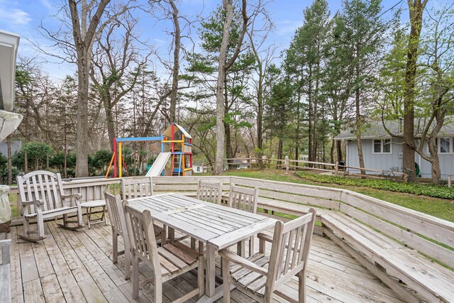 4117 Lake Shore Dr, New Buffalo, MI 49117 - wooden deck with outdoor dining area, fence, and a playground