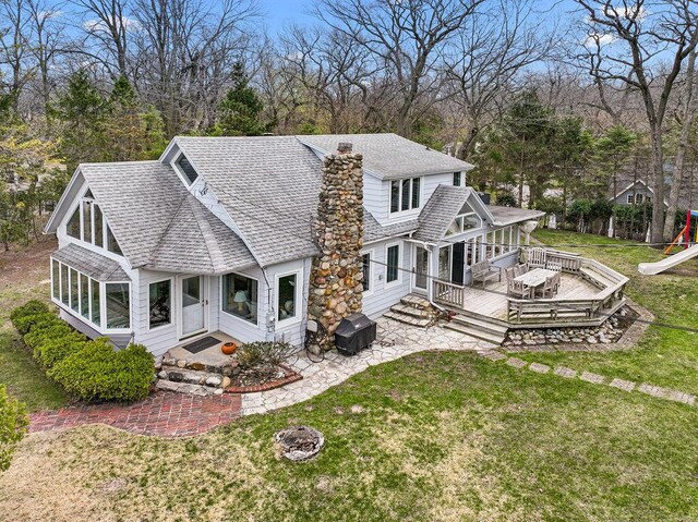 4117 Lake Shore Dr, New Buffalo, MI 49117 - back of property with a playground, a patio area, a lawn, roof with shingles, and a deck