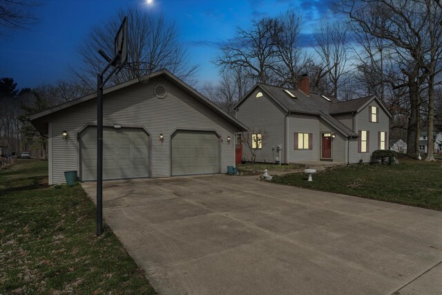 33028 Pokagon Hwy, Niles, MI 49120 - property exterior at dusk with driveway, an attached garage, a chimney, and a yard
