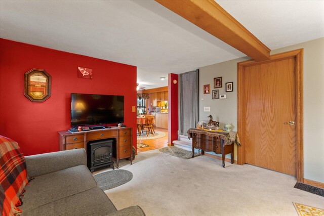 33028 Pokagon Hwy, Niles, MI 49120 - living area with beamed ceiling, a wood stove, and carpet