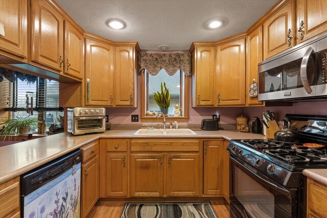33028 Pokagon Hwy, Niles, MI 49120 - kitchen featuring light countertops, stainless steel microwave, black gas range, a sink, and dishwasher