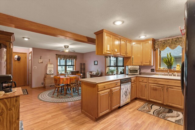 33028 Pokagon Hwy, Niles, MI 49120 - kitchen featuring light countertops, a sink, stainless steel dishwasher, and a peninsula