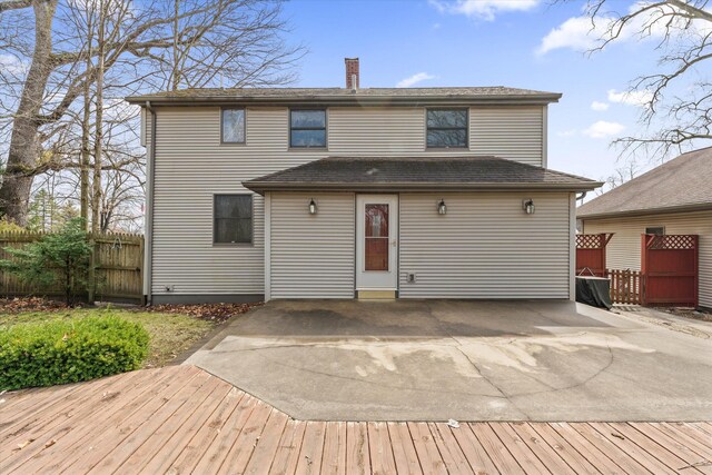33028 Pokagon Hwy, Niles, MI 49120 - back of house featuring a chimney, fence, and roof with shingles