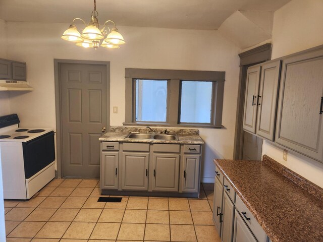 kitchen with light tile patterned floors, a sink, under cabinet range hood, an inviting chandelier, and electric range
