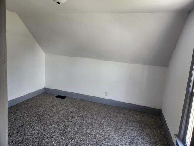 bonus room with visible vents, carpet flooring, and vaulted ceiling
