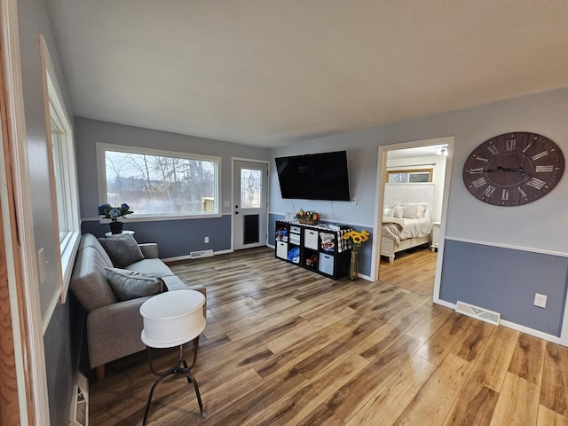 6162 Fuller Rd, Greenville, MI 48838 - living area featuring visible vents, baseboards, and wood finished floors