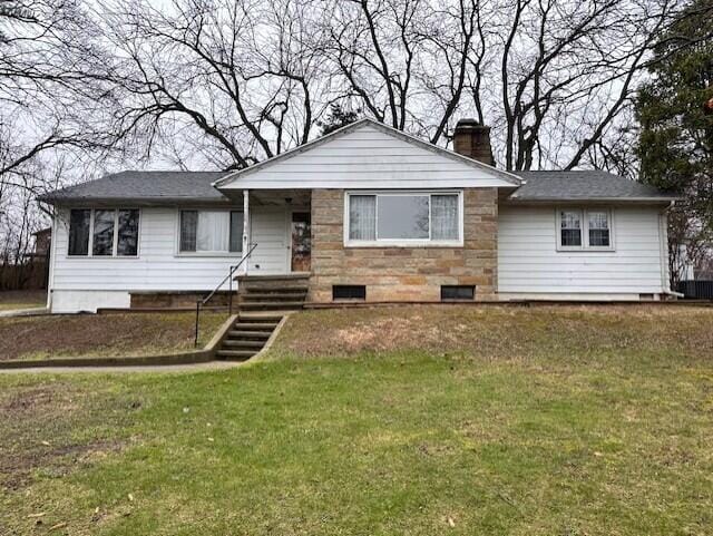 view of front facade with a chimney, crawl space, and a front lawn