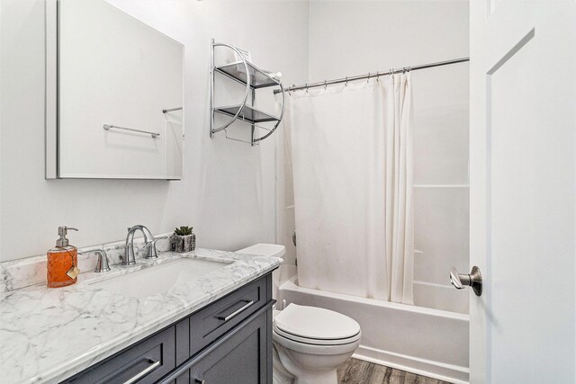 1641 N Arrowhead Rd, Mears, MI 49436 - bathroom featuring toilet, wood finished floors, vanity, and shower / bathtub combination with curtain