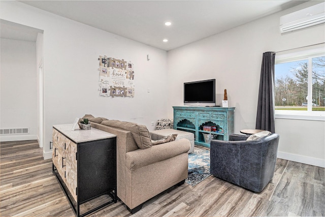 1641 N Arrowhead Rd, Mears, MI 49436 - living room featuring visible vents, an AC wall unit, light wood-type flooring, and recessed lighting