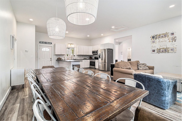 1641 N Arrowhead Rd, Mears, MI 49436 - dining area with baseboards, recessed lighting, and wood finished floors