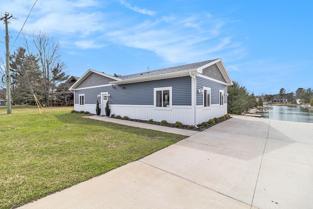 1641 N Arrowhead Rd, Mears, MI 49436 - view of side of property featuring a yard and concrete driveway