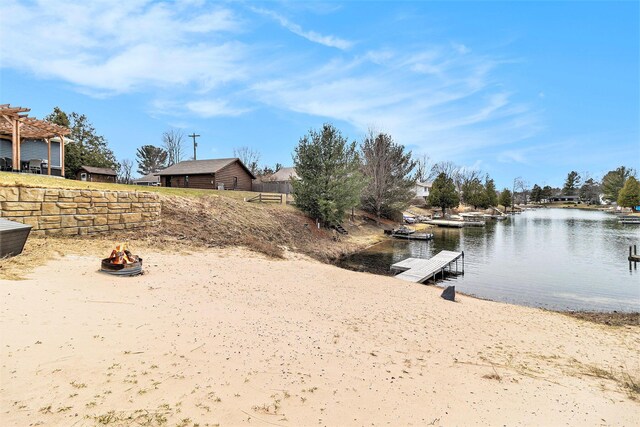 1641 N Arrowhead Rd, Mears, MI 49436 - view of yard featuring a pergola, a fire pit, a water view, and a boat dock