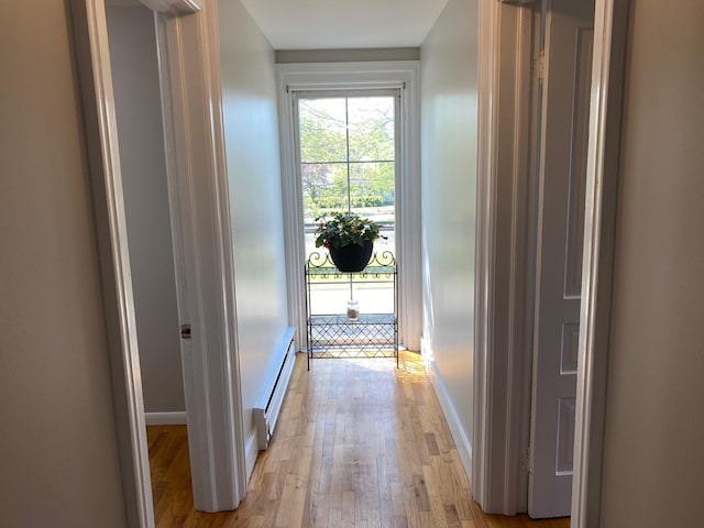 227 Railroad St, Chelsea, MI 48118 - corridor with light wood finished floors, a baseboard radiator, and baseboards