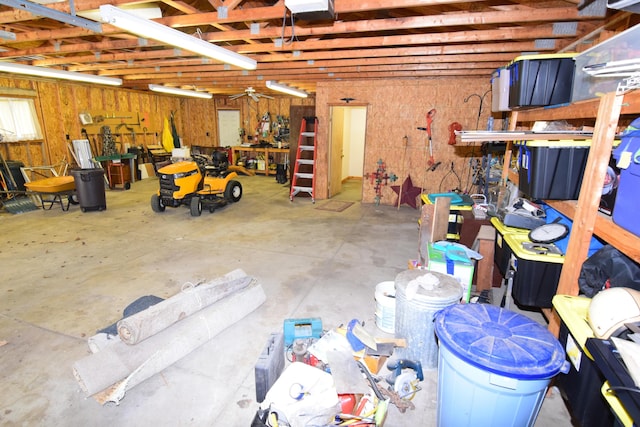 garage with a garage door opener and a workshop area