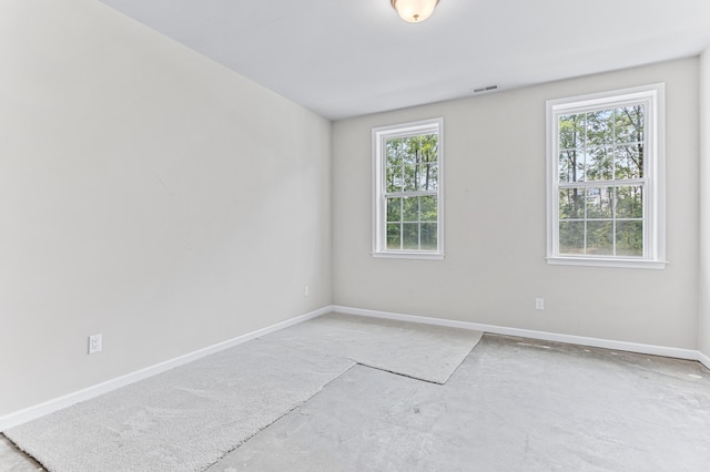empty room featuring baseboards and visible vents
