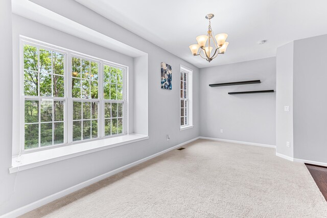 dining room with a notable chandelier, carpet, baseboards, and visible vents