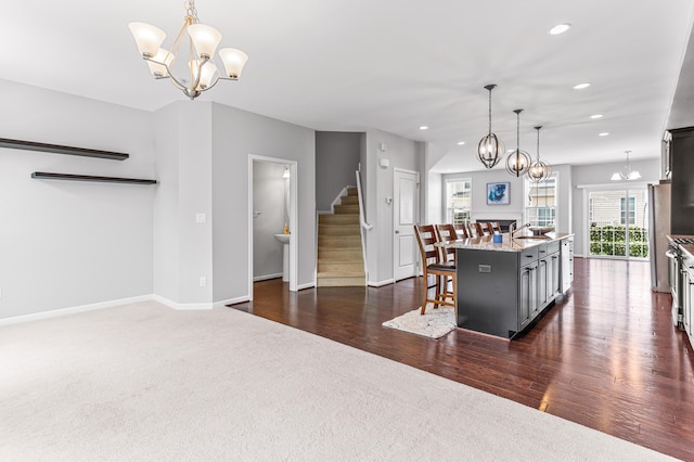 kitchen with an inviting chandelier, a kitchen breakfast bar, decorative light fixtures, and recessed lighting