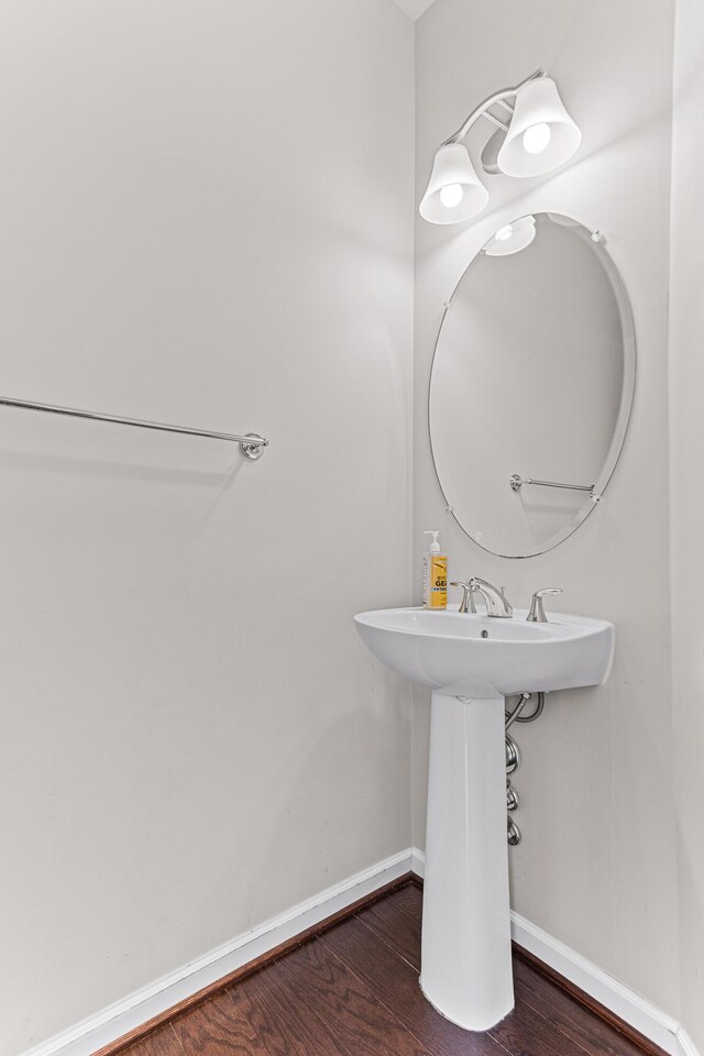 bathroom with baseboards and wood finished floors