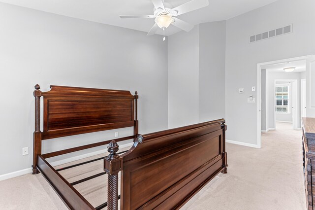 bedroom with ceiling fan, baseboards, light colored carpet, and visible vents