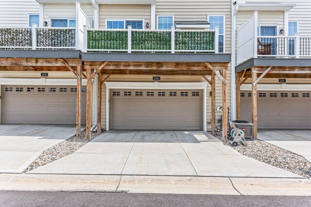 view of front of home with cooling unit and concrete driveway