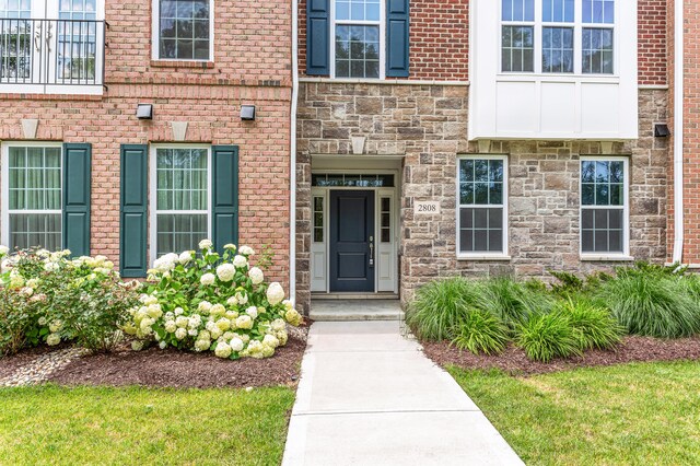 property entrance with brick siding