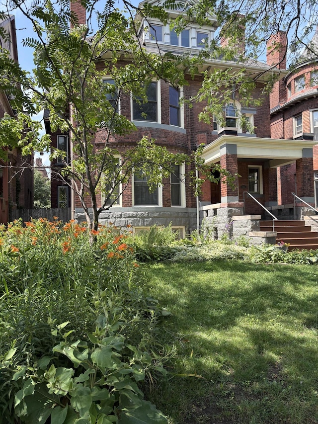 658 W Forest Ave, Detroit, MI 48201 - view of front facade with brick siding, a front yard, and a chimney