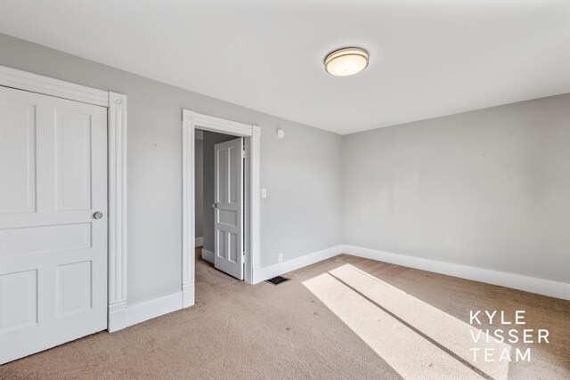 135 Houseman Ave NE, Grand Rapids, MI 49503 - unfurnished bedroom featuring baseboards, visible vents, and carpet floors