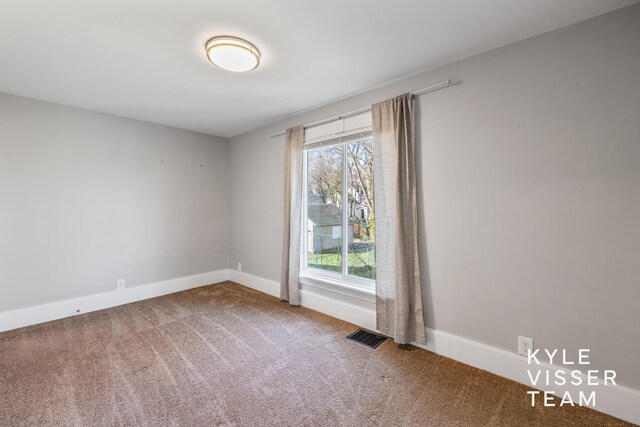 135 Houseman Ave NE, Grand Rapids, MI 49503 - carpeted empty room featuring baseboards and visible vents