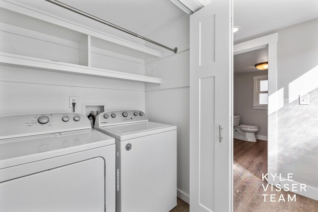 135 Houseman Ave NE, Grand Rapids, MI 49503 - laundry area featuring baseboards, wood finished floors, washing machine and clothes dryer, and laundry area