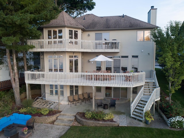 1761 S Shore Dr, Holland, MI 49423 - rear view of property with a balcony, a chimney, stairs, a shingled roof, and a patio area