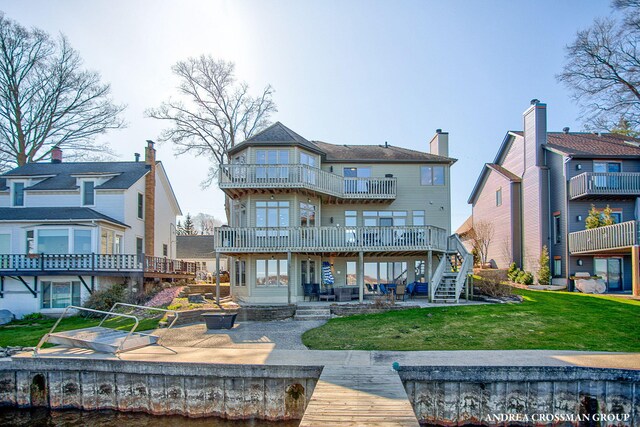 1761 S Shore Dr, Holland, MI 49423 - back of property featuring a patio, a lawn, and a balcony