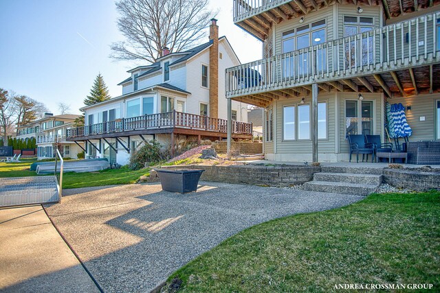 1761 S Shore Dr, Holland, MI 49423 - exterior space with a patio area and a lawn