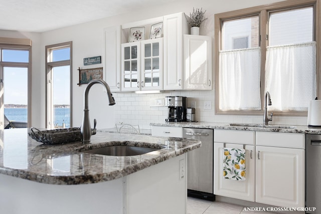 1761 S Shore Dr, Holland, MI 49423 - kitchen featuring dishwasher, white cabinets, and a sink