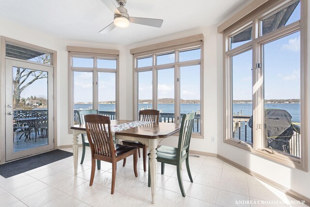 1761 S Shore Dr, Holland, MI 49423 - dining area with a ceiling fan, light tile patterned flooring, a water view, and baseboards