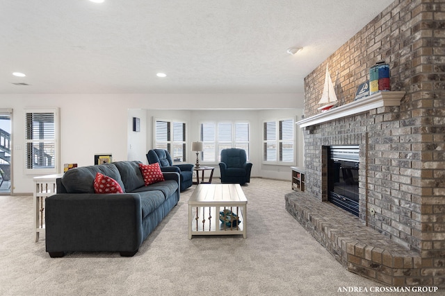 1761 S Shore Dr, Holland, MI 49423 - carpeted living room with a textured ceiling, a fireplace, a healthy amount of sunlight, and recessed lighting