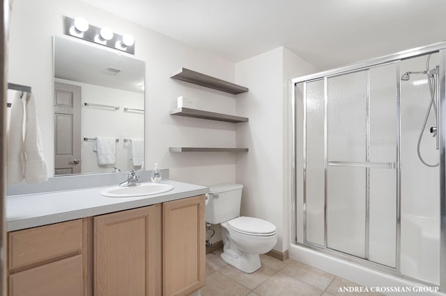 1761 S Shore Dr, Holland, MI 49423 - bathroom with vanity, toilet, tile patterned flooring, and a shower stall