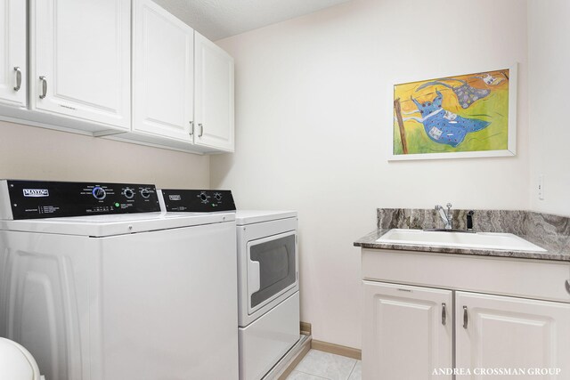 1761 S Shore Dr, Holland, MI 49423 - laundry room featuring light tile patterned flooring, independent washer and dryer, baseboards, a sink, and cabinet space